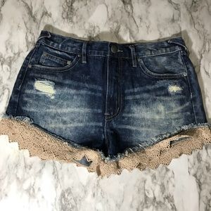 Free people distressed jean shorts with lace